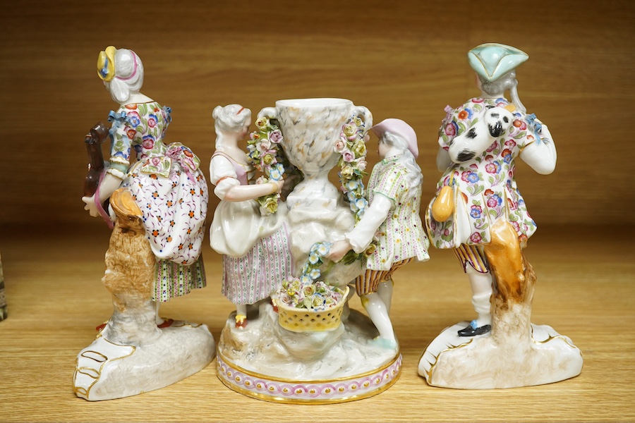 A 19th century Jacob Petit urn group and two similar porcelain figures of musicians, each signed to the bases, largest 20cm high (3). Condition - fair